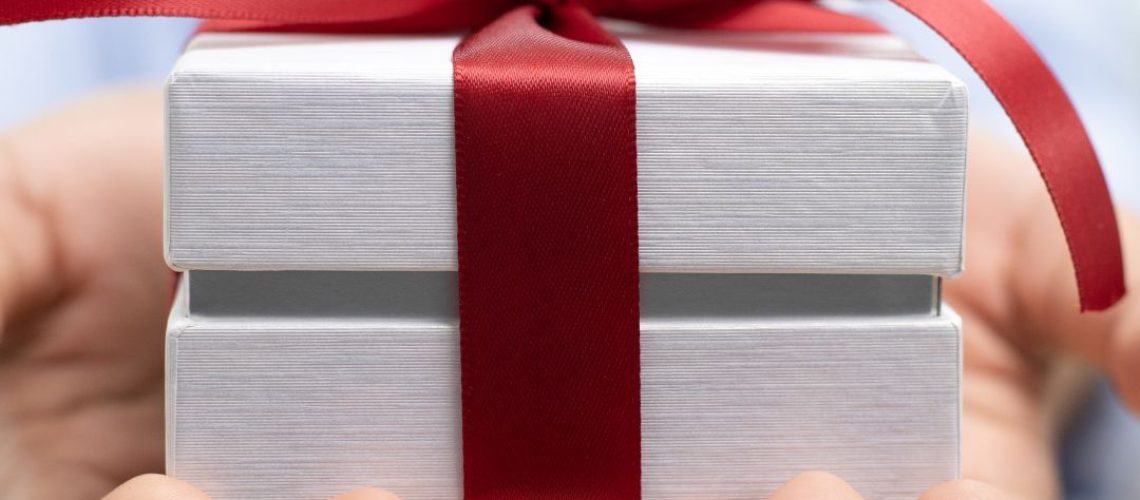 Gift presented to someone. Red Ribbon